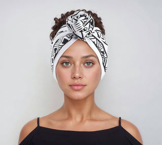 Woman with natural hair wearing a satin lined headband in white and black.