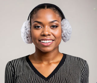 Woman wearing faux fur earmuffs in black and white.